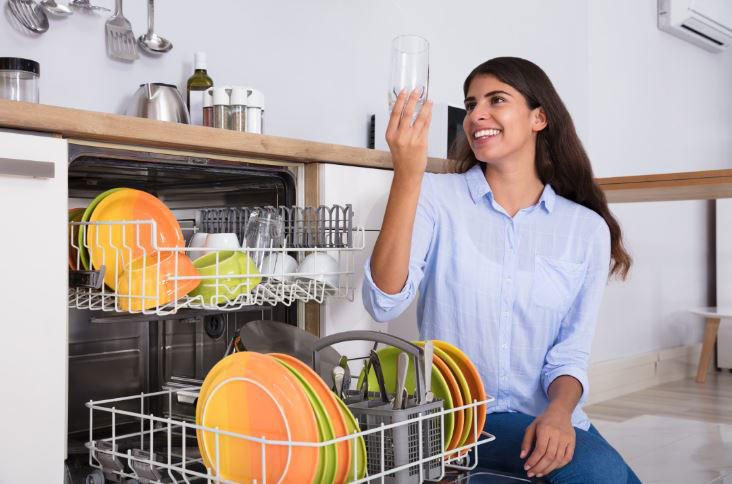 Person looking at clean dishes from dishwasher